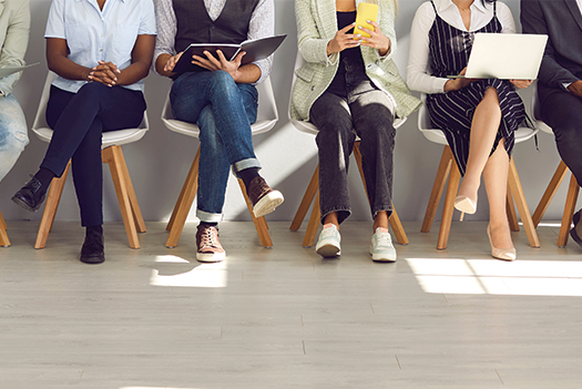 Image of hand holding pen writing on paper, with calculator nearby