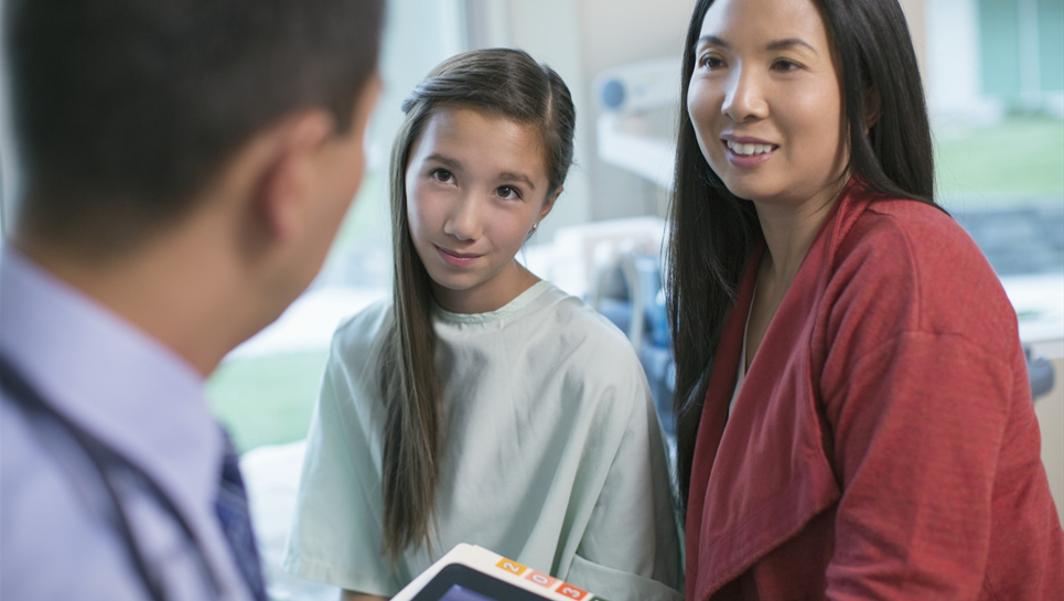 two women looking at a doctor
